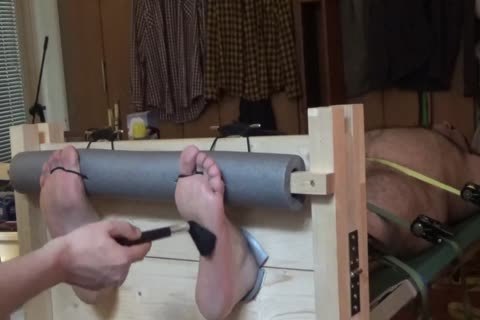 naked Bear Tickled In Stocks And On A Rack